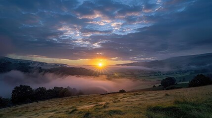 Fototapeta premium Sunrise breaking through morning clouds over a valley, fresh start to the day, dawn light
