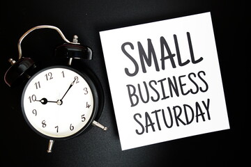 Small Business Saturday text with alarm clock on black background