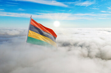 Mauritius flag aerial view in beautiful sky with clouds. Top-down drone shot at sunrise or sunset. Aerial bird's eye view of the flag with cloudscape.