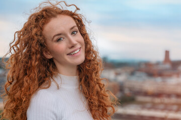 Smiling Redhead Woman Smiling Outdoors in Urban Setting