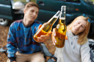 Outdoor Bliss: Couple, Beer, and Minivan in Nature
