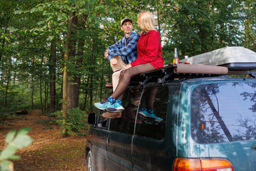 Young Couple Relaxing Above Van in Nature