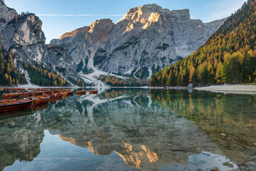 Lago di braies lake in the dolomites in autumn, reflection on the water