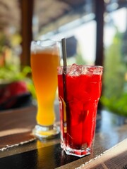 cocktail on the table. Summer soft drink with pieces of fruit and beer on wooden table. Refreshing summer beverage for hot weather. Delicious cold drink with mint. 