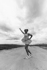 Obraz premium Portrait of a beautiful blonde girl outdoors. Black and white photo.