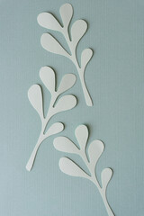 gray-green paper leaves on jade green textured paper
