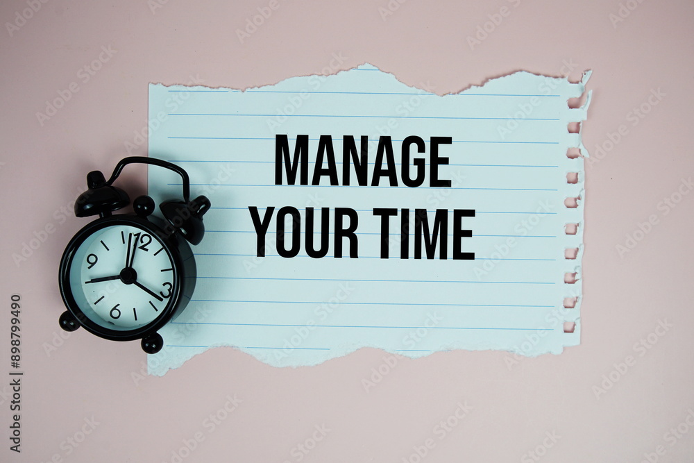 Poster manage your time quotes text on paper torn with alarm clock top view on pink background