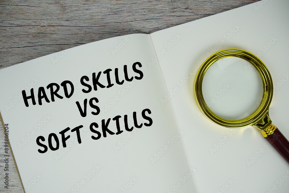 Poster hard skills vs soft skills text with magnifying glass top view on wooden background