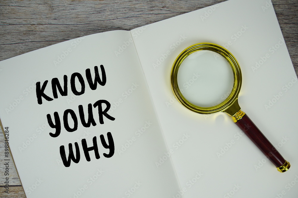 Poster know your why text message written on note page with magnifying glass top view on wooden background