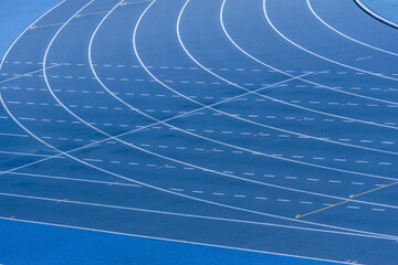 Blue track and field lanes. Running lanes at a track and field athletic stadium. Horizontal sport...