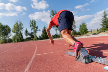 Stadium, man running and start block of athlete on a runner and arena track for sprint