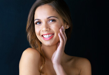 Fototapeta premium Woman, portrait and skincare for beauty in studio with makeup, glowing skin and smile for dermatology treatment. Model, cosmetics or happy girl with foundation and self care on blue background mockup