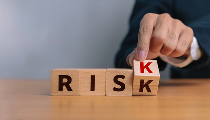 Naklejka premium Risk management concept. Businessman hand put risk word on wooden block cube for financial banking analysis and business management.