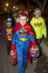 Fototapeta premium Kids Trick-or-Treating in Halloween Costumes