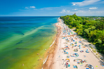 Flying above beach with people in Baltic Sea, Poland