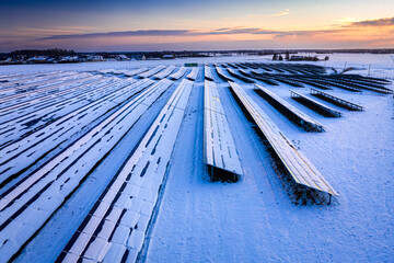 Solar panels covered by snow in winter as alternative energy.