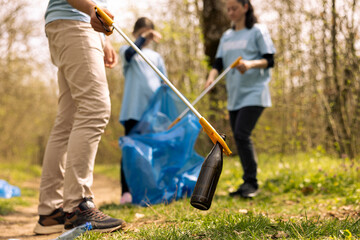 Team of volunteers collecting garbage and plastic waste to recycle, cleaning the natural habitat...
