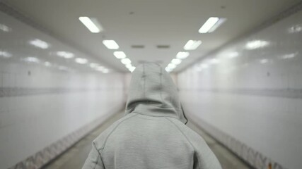 4K African man in sportswear enjoy outdoor active lifestyle sport training jogging exercise in the city. Male athlete running workout in street crossing tunnel at night. Health care motivation concept