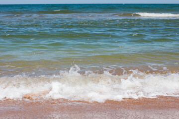 foam waves on a sandy beach. Seascape