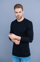 Casual male style. Young Caucasian man isolated on grey. Confident man face portrait. Men skin care. Skincare of men. Guy has stylish haircut. Man with trendy hairstyle. Casual cool