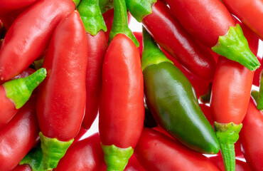 Set of small red chillies, one green isolated.Use for image background.