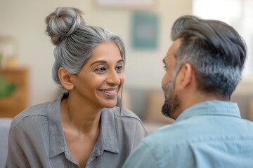 Middle-aged South Asian couple smiling at each other, symbolizing love, happiness, and companionship. Concept of relationship, marriage, and emotional connection