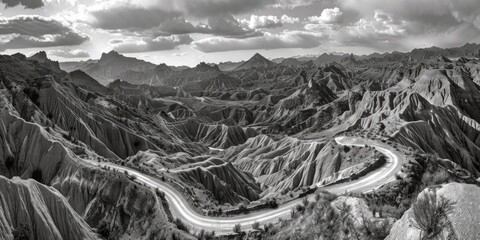 Fototapeta premium A quiet country road with a gentle curve, captured in monochrome