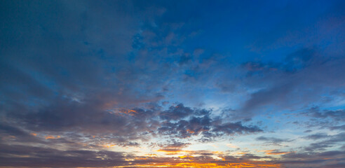 Beautiful Vivid sky painted by the sun leaving bright golden shades.Dense clouds in twilight sky in winter evening.Image of cloud sky on evening time.Evening Vivid sky with clouds