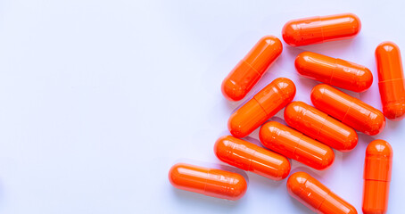 Orange pill capsules isolated on white background,Medicine background. Orange pills isolated on...