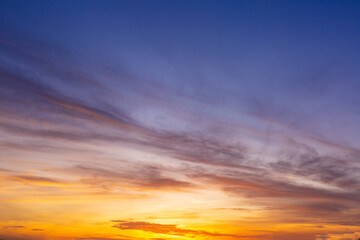 Beautiful Vivid sky painted by the sun leaving bright golden shades.Dense clouds in twilight sky in winter evening.Image of cloud sky on evening time.Evening Vivid sky with clouds