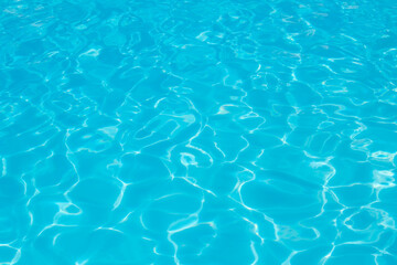Fototapeta premium blue water surface background with ripples and sunray pool 