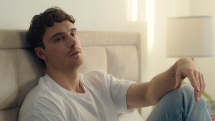 Caucasian European man pensive thoughtful thinking sadness bored bedroom bed home male tired guy failure grief loneliness upset sigh contemplation boredom reflection solitude frustration exhaustion