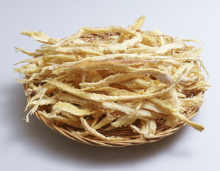 Close-up of stacked dried Hwangtae(Dried Pollack) in pieces on bamboo basket, South Korea
