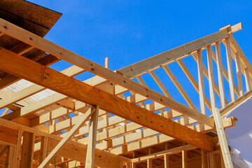 New home building framing with wooden truss, post beam framework in construction site