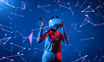 Female standing wearing white VR headset and tank top connecting metaverse, future cyberspace...