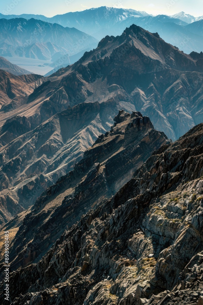 Poster a person on a mountain top with mountains in the background