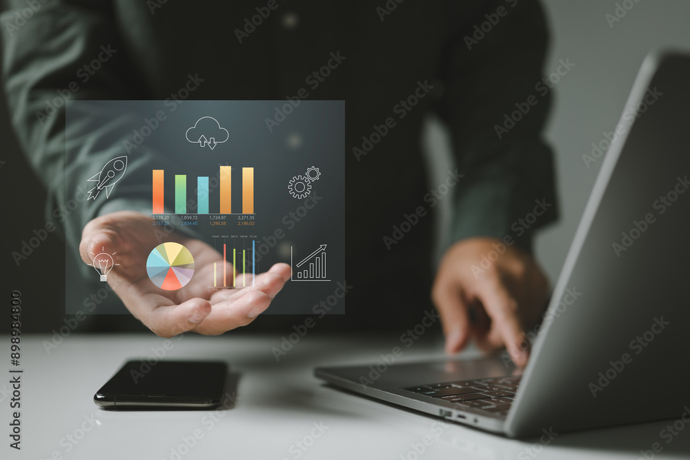Leinwandbilder Person with data charts and graphs hovering above their hand, symbolizing the power of digital technology in analyzing information, tracking performance, and driving business growth.