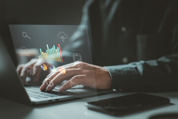 Person typing on a laptop with various data charts and icons. It symbolizes the use of digital...