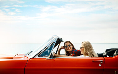 Friends, woman and driving convertible for road trip, adventure and freedom or luxury on vacation....