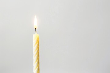 Celebratory silhouette of a Lit Candle in Minimalist Setting