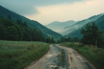 Naklejka premium A dirt road winding its way through the mountains, perfect for outdoor adventures or scenic views