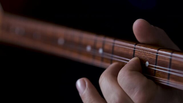 Male hands playing Turkish traditional music Instrument Baglama, Saz. Close up view, 4k