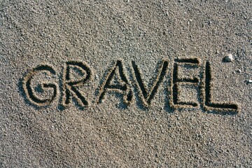 gravel written in the dark rough sand