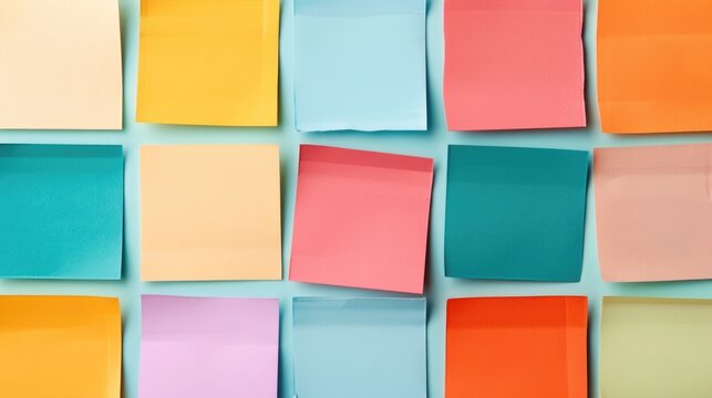 Vibrant flat lay arrangement of various shaped and colored sticky notes with deep depth of field creating a minimal and modern abstract office or school supply composition