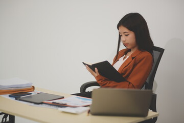 A driven and dedicated young professional showcases her efficiency and attention to detail as she works diligently on her laptop