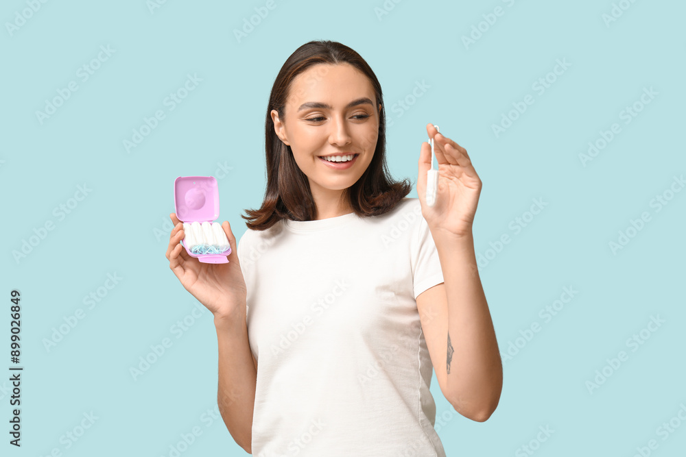 Sticker beautiful young woman with tampons storage box on blue background