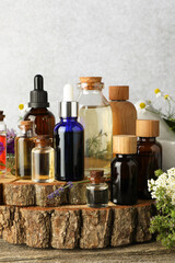 Aromatherapy. Different essential oils and flowers on wooden table