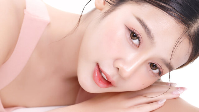 Beautiful young Asian woman with K beauty style makeup and perfect skin on isolated white background. Facial and skin care concept for commercial advertising.