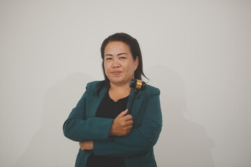 Pretty Asian female lawyer working and hammer, laptop, justice advice and legal concept. In office