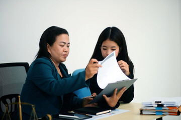 Pretty Asian female lawyer working and hammer, laptop, justice advice and legal concept. In office